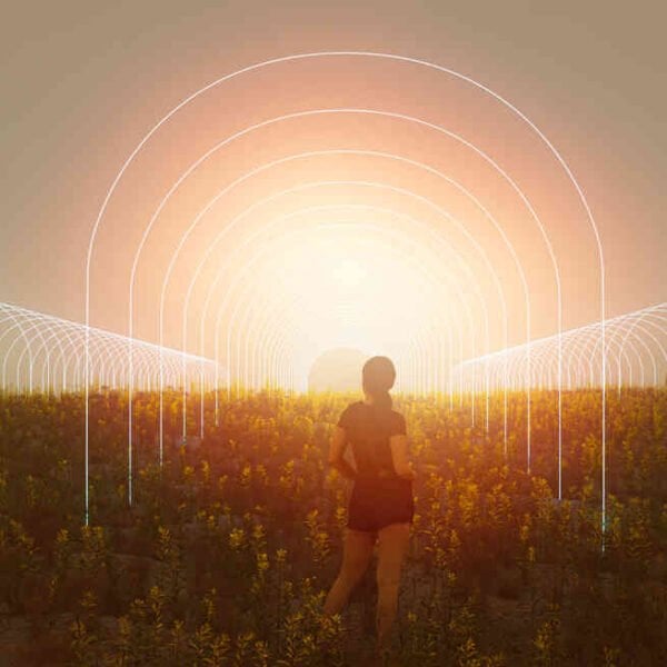 A person stands in a field with glowing arched pathways extending to the horizon, against a bright, hazy sky, much like the radiant promise of an Early Girls Multipack (F).