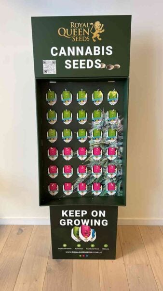 A Royal Queen Seeds Display features multiple packs of cannabis seeds. The bottom section reads "Keep on Growing," while a QR code at the top offers additional information.